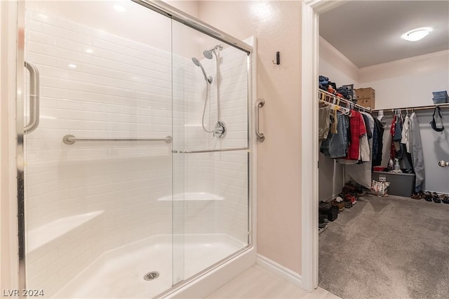 bathroom with a shower with shower door