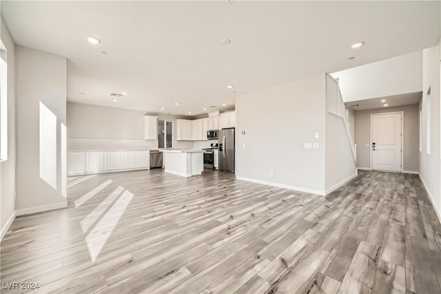 unfurnished living room featuring light hardwood / wood-style flooring