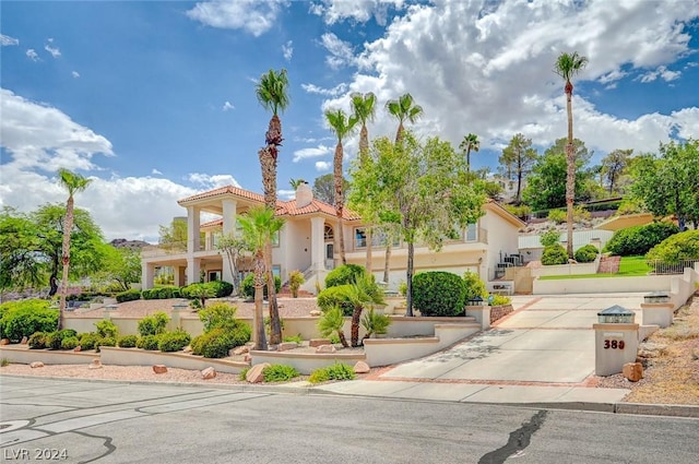 mediterranean / spanish-style house with a garage