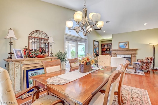 dining room featuring an inviting chandelier and hardwood / wood-style flooring