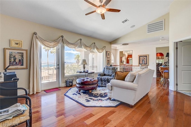 living room featuring hardwood / wood-style floors, ceiling fan, and lofted ceiling