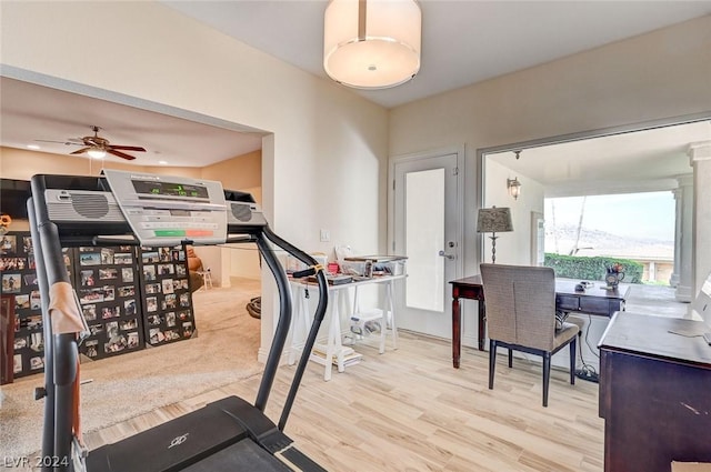 workout area featuring ceiling fan and light hardwood / wood-style floors