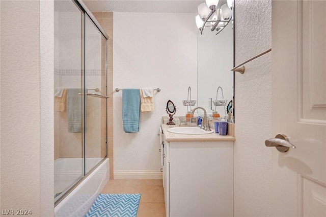 bathroom with tile patterned floors, vanity, a notable chandelier, and combined bath / shower with glass door