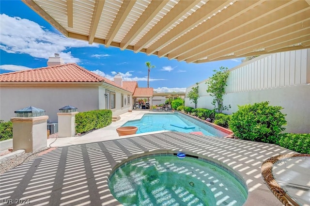 view of pool featuring an in ground hot tub and a patio