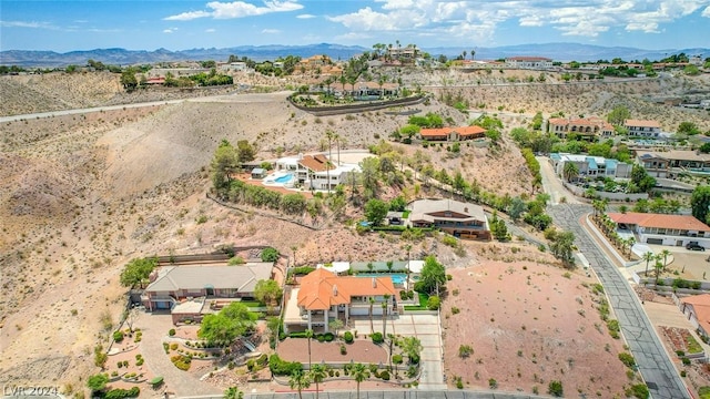 birds eye view of property with a mountain view