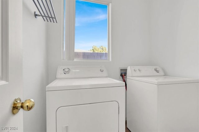 clothes washing area featuring washer and dryer