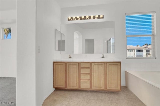 bathroom with vanity, tile patterned flooring, and plus walk in shower