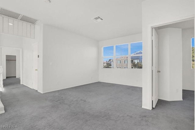 unfurnished room with dark carpet