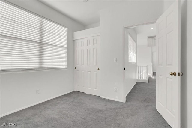 unfurnished bedroom featuring a closet and carpet floors