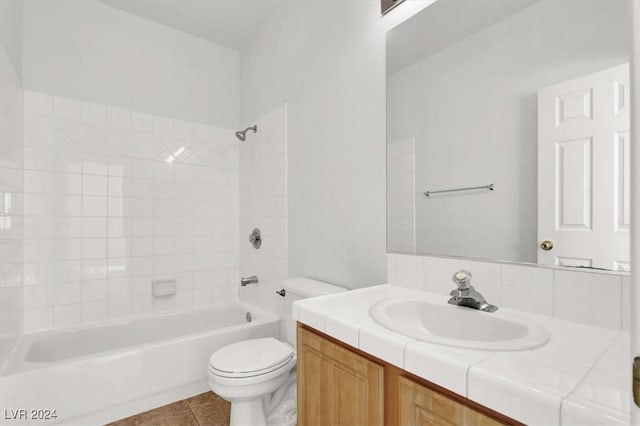 full bathroom featuring toilet, tiled shower / bath combo, tile patterned floors, and vanity