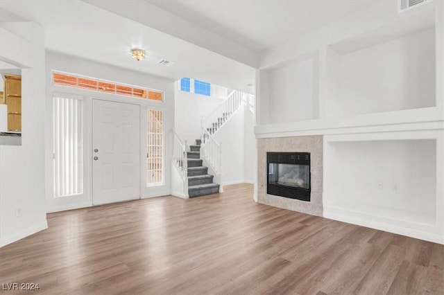 entryway featuring hardwood / wood-style floors and a fireplace