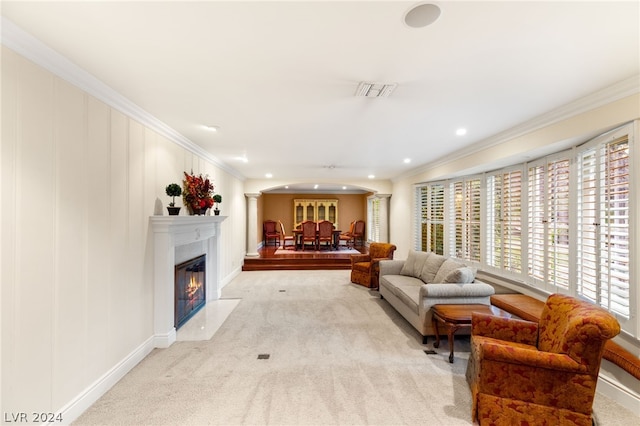 living room with light carpet, ornamental molding, and ornate columns