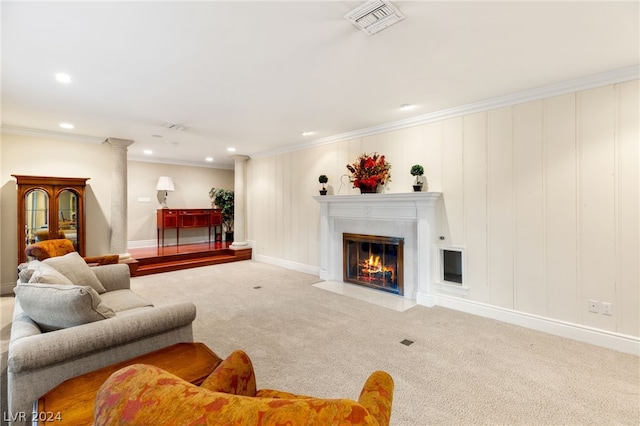 carpeted living room with ornamental molding and decorative columns