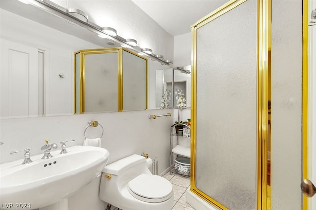 bathroom with toilet, tile patterned floors, an enclosed shower, and sink