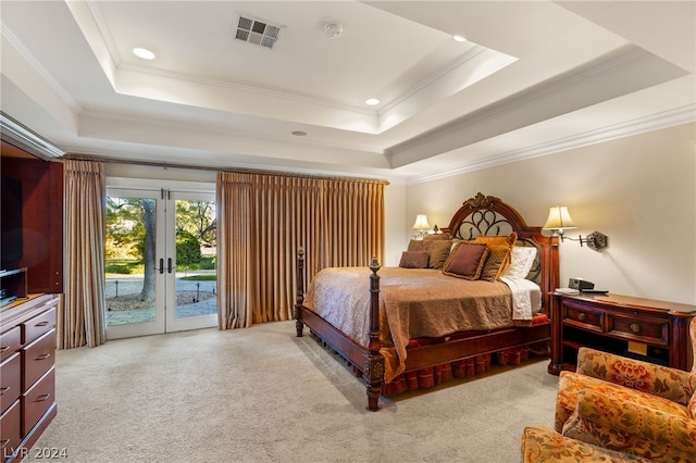 bedroom featuring light colored carpet, crown molding, a tray ceiling, and access to outside