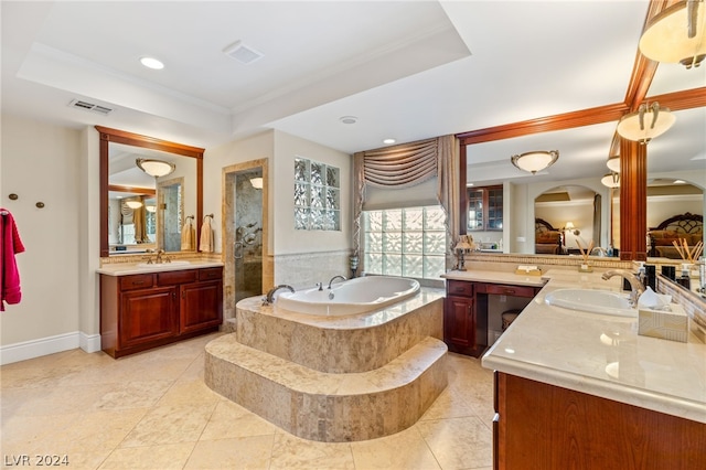 bathroom featuring crown molding, a relaxing tiled tub, a raised ceiling, and vanity