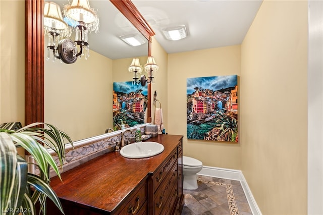 bathroom with toilet, tile patterned floors, and vanity