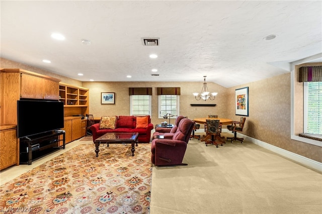 living room featuring light colored carpet, a textured ceiling, and a notable chandelier