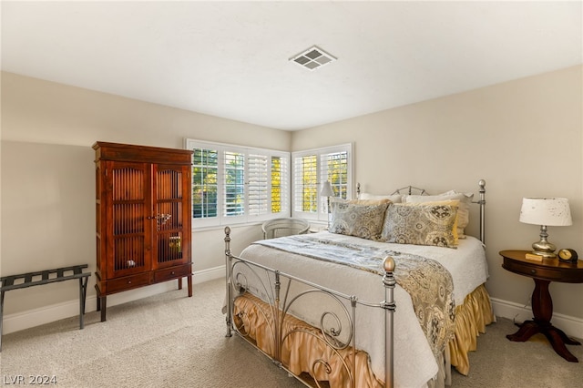 bedroom featuring light colored carpet