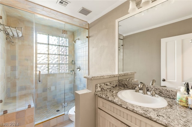 bathroom featuring toilet, ornamental molding, walk in shower, and vanity