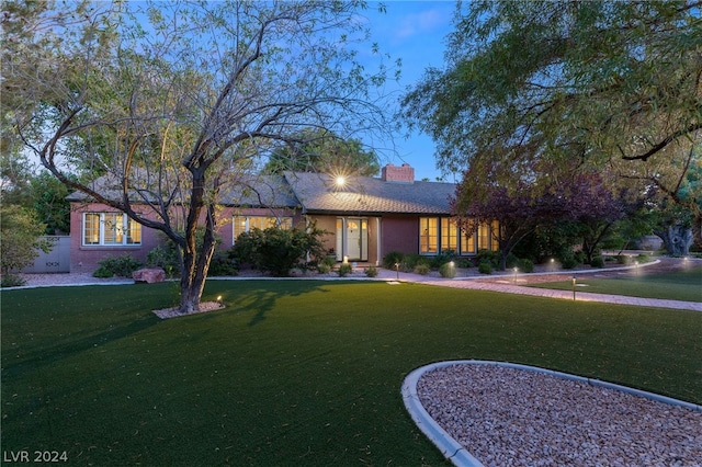 ranch-style home featuring a front yard