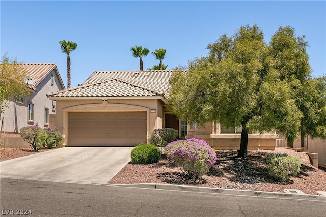 mediterranean / spanish-style home featuring a garage