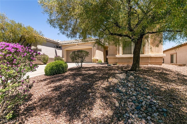 mediterranean / spanish-style house with a garage