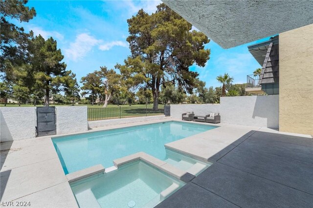 view of pool with an in ground hot tub, a patio area, and an outdoor hangout area