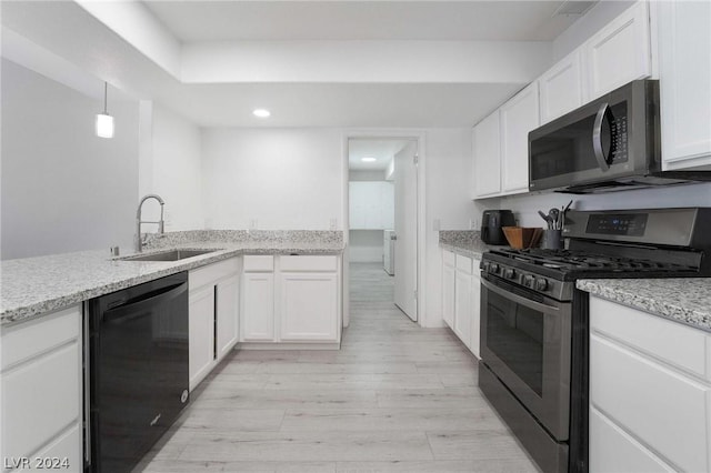 kitchen with stainless steel gas stove, sink, white cabinetry, and black dishwasher