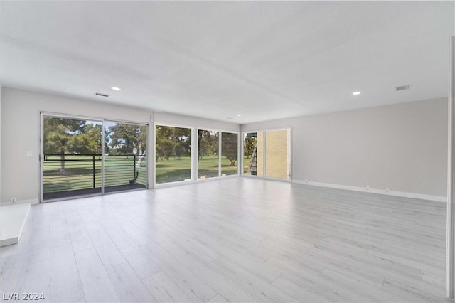 spare room with light hardwood / wood-style floors