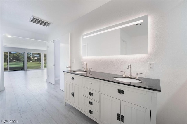 bathroom featuring hardwood / wood-style flooring and vanity