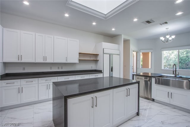 kitchen featuring white cabinets, sink, dishwasher, paneled built in refrigerator, and light tile patterned floors