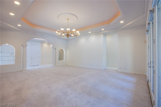 empty room with a chandelier and a tray ceiling