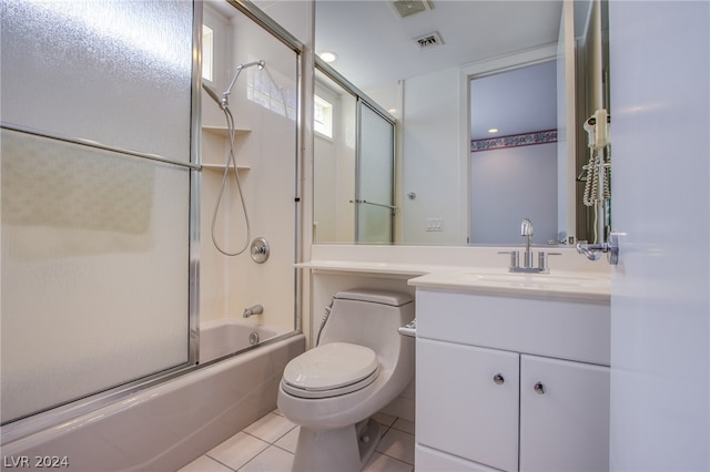 full bathroom with tile patterned floors, toilet, enclosed tub / shower combo, and vanity