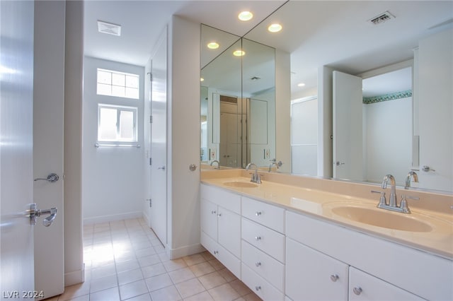 bathroom with dual vanity and tile patterned floors