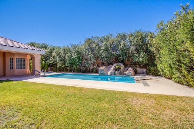 view of pool with a yard and a patio