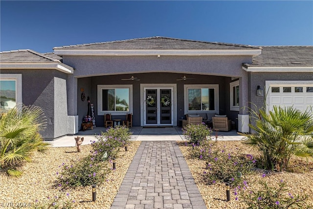 property entrance with a garage, a patio, and ceiling fan