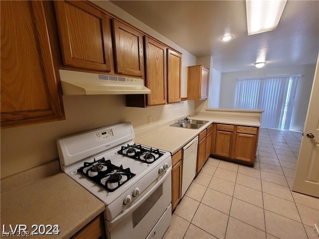 kitchen featuring light tile patterned flooring, sink, and white appliances