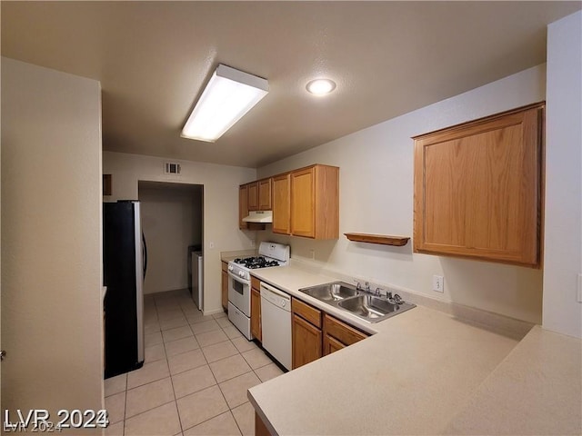 kitchen featuring light tile patterned floors, sink, washer / clothes dryer, and white appliances