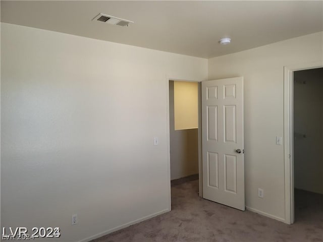 unfurnished room with light carpet