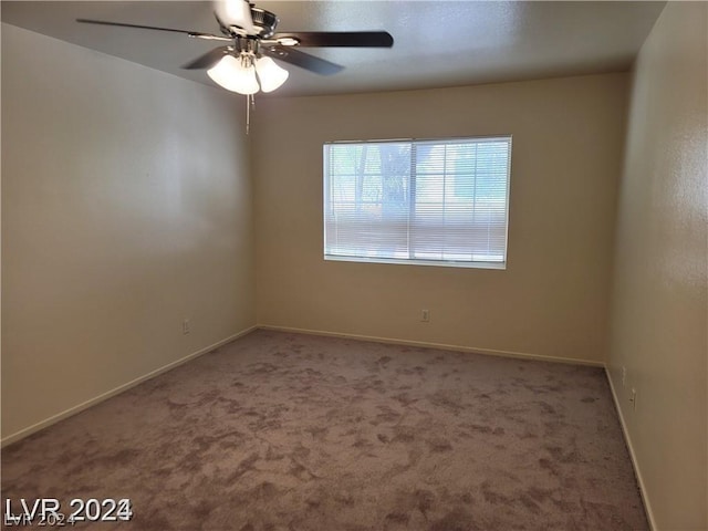 spare room featuring ceiling fan and carpet