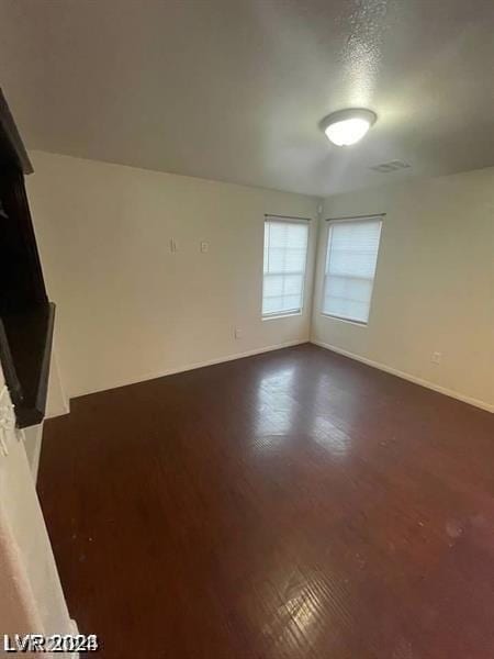 unfurnished room with a textured ceiling