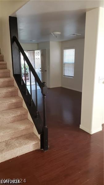 stairs featuring hardwood / wood-style flooring