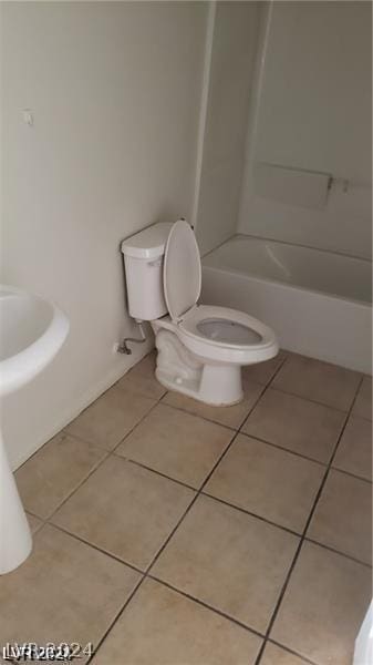 bathroom with toilet, tub / shower combination, and tile patterned floors