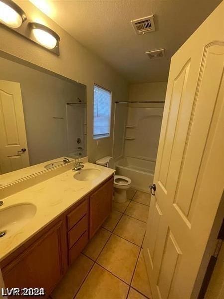 full bathroom featuring toilet, vanity, tile patterned floors, shower / bathtub combination, and a textured ceiling