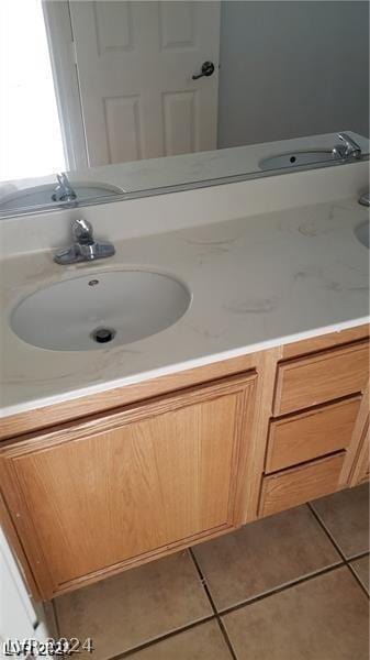 bathroom with tile patterned floors and vanity