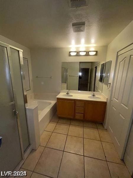 bathroom with separate shower and tub, vanity, tile patterned floors, and a textured ceiling