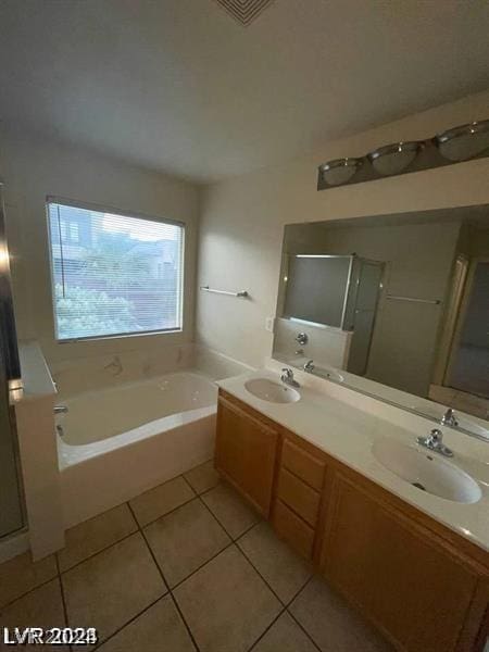 bathroom featuring independent shower and bath, tile patterned flooring, and vanity