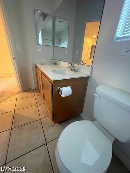 bathroom featuring toilet, tile patterned floors, and vanity