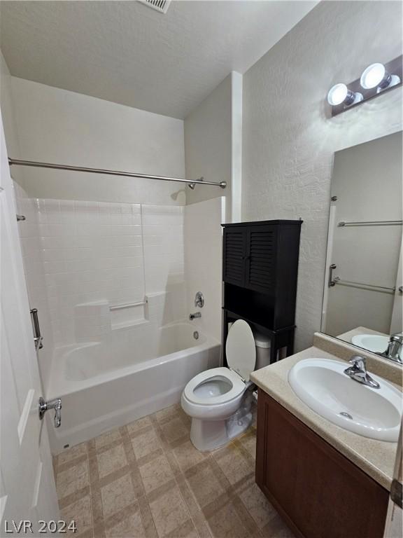 full bathroom featuring vanity, bathing tub / shower combination, and toilet